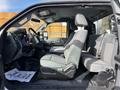 Interior of a 2011 Ford F-450 SD featuring gray seats with a simple design and a steering wheel visible in the front