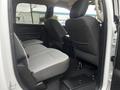 Interior view of a 2022 RAM 1500 Classic showing the back seat area with gray fabric upholstery and a center armrest console