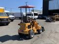 A 2024 Traner TR 45 is a compact construction vehicle with a yellow body a front loader attachment and a red canopy over the operator's seat