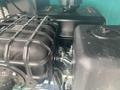 A close-up view of the engine compartment of a 2024 AGT Industrial MH12R Mini Excavator showcasing various components including the air filter and engine parts