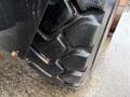 Close-up of a rugged tire from a 2018 Doosan DL300-5 showcasing deep treads designed for heavy-duty performance and traction