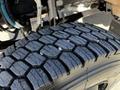 Close-up view of the tread on a tire from a 2022 Blue Bird Vision showcasing deep grooves and a rugged surface designed for traction