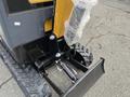 A yellow H13R Mini Excavator showing its tracks hydraulic arm and bucket attachment