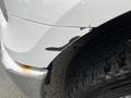 A 2016 Ford F-150 with a damaged front corner showing scuffed paint and a worn tire with visible tread pattern