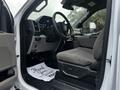 Interior view of a 2021 Ford F-550 showing the driver's seat steering wheel and dashboard with a floor mat that says Thank You