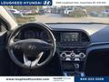 Interior of a 2020 Hyundai Elantra featuring a modern dashboard an infotainment screen and a multi-function steering wheel