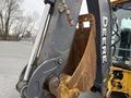 A 2011 John Deere 310SJ 4x4 Wheel Loader Extended Hoe with a 4 in 1 bucket showing wear and rust on the bucket edges and hydraulic components