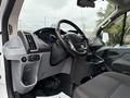 Interior view of a 2017 Ford Transit T150 XLT showing the steering wheel dashboard and front seats