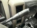 Close-up of the gear shift lever in a 2012 Dodge Ram 5500 with audio controls and climate knobs visible on the dashboard