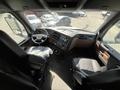 Interior view of a 2022 Freightliner Cascadia featuring the driver seat dashboard and controls