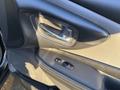 Close-up of the door handle and control panel of a 2021 Nissan Murano showing the door lock and window controls