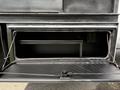 The image shows an open storage compartment of a 2008 Ford F-550 with a black interior and metal framing visible inside the compartment