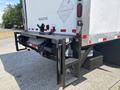 A 2015 Freightliner M2 106 with a hydraulic liftgate attached at the rear designed for loading and unloading heavy items