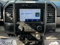 Dashboard of a 2021 Ford F-550 featuring a touchscreen display with media controls and various buttons