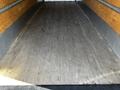 Interior view of a 2021 Hino 338 truck showing a wooden floor with metal edges and a clean design