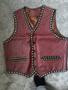 A red leather vest featuring black trim and decorative bead-like accents with five buttons and two front pockets
