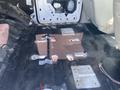 Interior view of a 2013 Ford Expedition showing the stripped floor with exposed wiring and fittings