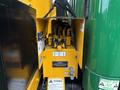 A yellow control panel with various valves and levers is mounted on the side of a 2015 Freightliner M2 106 truck showcasing hydraulic connections and warning labels