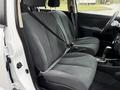 Interior of a 2012 Nissan Versa featuring a front seating area with two upholstered seats and a console between them
