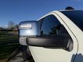 Close-up of the side mirror of a 2023 RAM 3500 showing the sleek design and integrated lights