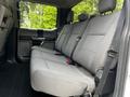 Interior view of a 2020 Ford F-350 Super Duty showing the rear bench seat with gray fabric upholstery and seatbelts