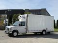 A white 2019 Ford Econoline box truck with a refrigerated unit on top and standard wheels parked on a lot