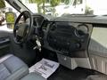 Interior view of a 2016 Ford F-550 with a gray dashboard and seats featuring a stereo system and various controls