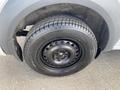 Close-up of a black wheel and tire of a 2013 Ford Transit Connect showing the tread pattern and wheel design