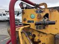 Close-up of a 2015 Vermeer Corporation BC1200XL with a yellow and rusted panel featuring operator controls and instruction icons