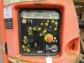 Control panel of a 2009 JLG E300AJP featuring various buttons levers and directional arrows for operating the equipment