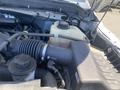 Close-up of the engine compartment of a 2015 Ford F-450 SD showing various components including air intake and coolant reservoir