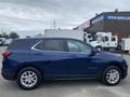 A blue 2022 Chevrolet Equinox parked at an angle showcasing its sleek design and alloy wheels