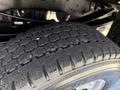 Close-up of a tire from a 2012 Ford F-350 SD showing a detailed tread pattern designed for traction and stability