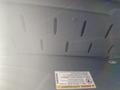 Image shows the interior of a 2017 Mercedes-Benz Sprinter highlighting the underside of a panel with ventilation slits and a warning label