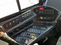 The control panel of a 2022 Blue Bird Vision featuring various switches buttons and a radio display