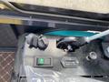 Control panel of a 2024 AGT Industrial QH13R Mini Excavator featuring ignition key slot hour meter and various toggle switches