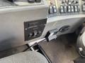 Interior control panel of a 2015 Global Street Sweeper featuring various buttons switches and a small display unit