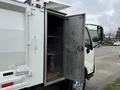 A 2014 Hino 195 truck with an open rear door revealing an empty cargo space with shelves inside