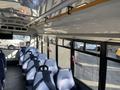 Interior view of a 2017 Chevrolet Express with blue seats and overhead handles visible