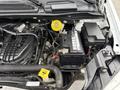A 2017 Dodge Grand Caravan engine compartment showcasing the battery and various engine components including cables and hoses
