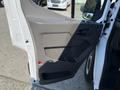 A 2022 Ford Transit van door interior showing a gray panel with a handle and armrest