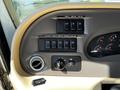 Dashboard controls of a 2000 Ford Motorhome featuring various switches knobs and gauges