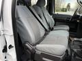 A 2016 Ford F-550 Super Duty with gray upholstered front seats featuring a patterned design and seatbelts installed