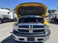 A 2015 RAM 1500 truck with its hood open displaying the engine compartment