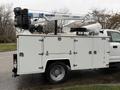 A 2017 Ford F-550 truck with a white utility body features a hydraulic lift on top designed for aerial work