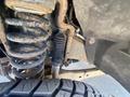 Close-up of the suspension system and tire of a 2016 Ford F-350 SD showcasing the coil spring and shock absorber