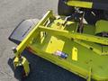 A yellow Kubota F3990 mower deck with a lowered cutting blade attached and a wheel at the front