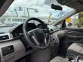 Interior view of a 2014 Honda Odyssey showcasing the steering wheel dashboard and control panel with gear shifter and seating area visible in the foreground