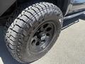 A close-up of a tire on a 2010 Toyota Tacoma with deep tread patterns and a black alloy wheel featuring the Falken logo