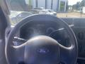 Steering wheel of a 2009 Ford Econoline with dashboard controls and instrument cluster visible